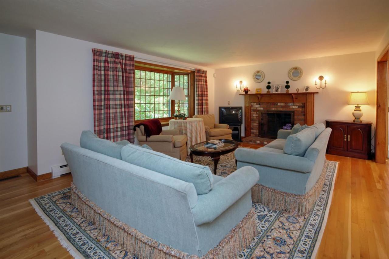 43 Piney Road Cotuit, MA 02635 - Photo 6 of 31 a living room with furniture and a fireplace
