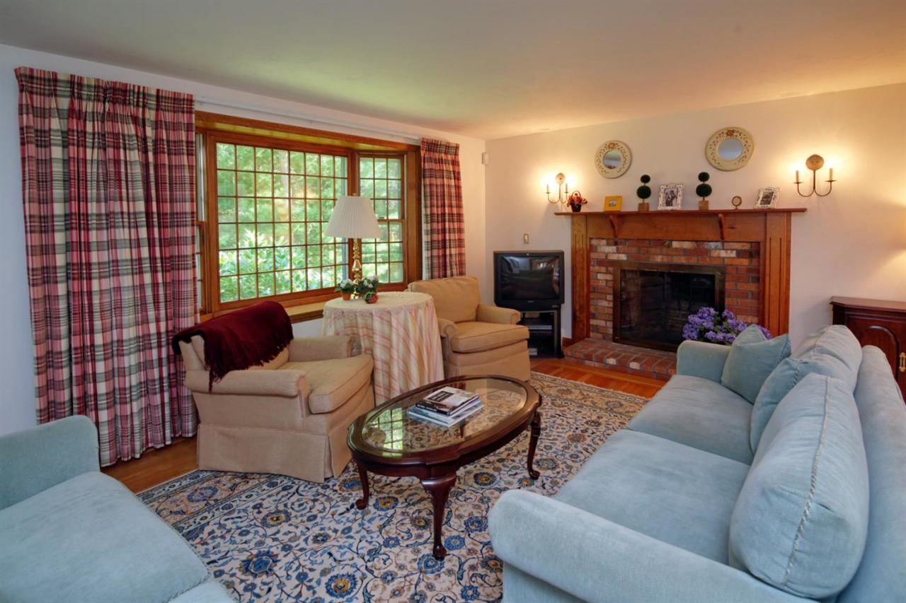 43 Piney Road Cotuit, MA 02635 - Photo 7 of 31 a living room with furniture and a fireplace