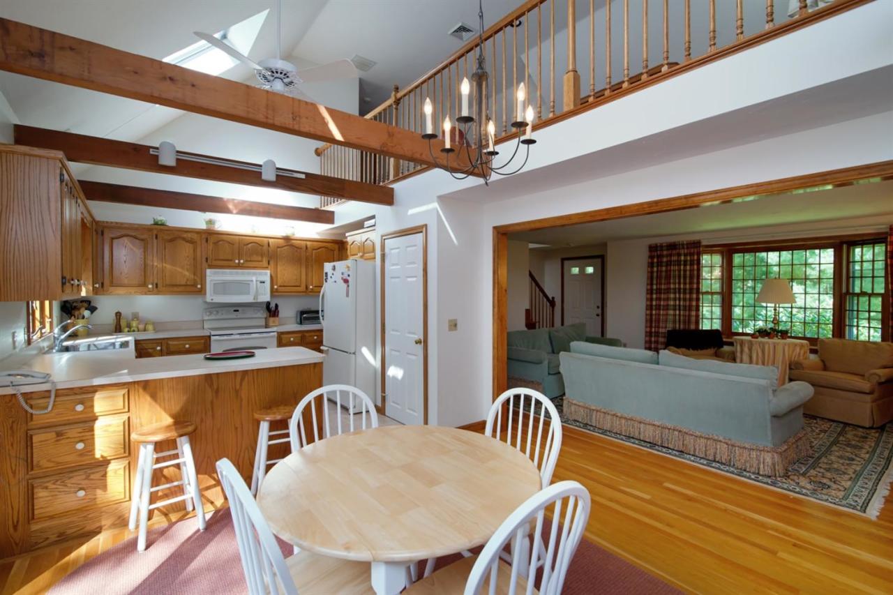 43 Piney Road Cotuit, MA 02635 - Photo 8 of 31 a dining room with furniture a chandelier and wooden floor