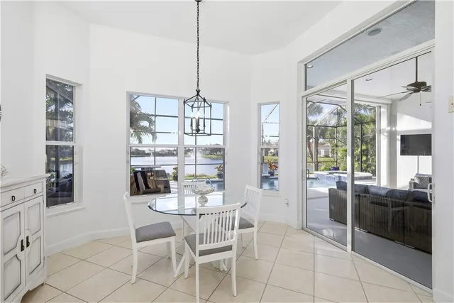 a view of a dining room with furniture large windows and wooden floor