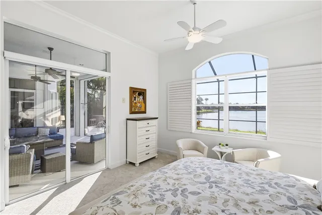 a bedroom with furniture and a large window