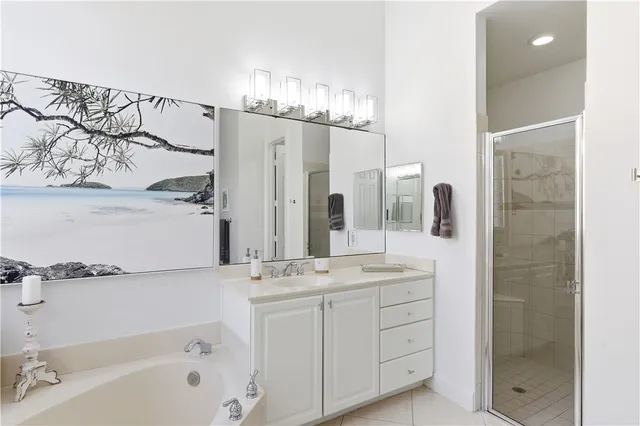 a bathroom with a double vanity sink a mirror and a bathtub