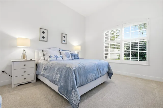 a spacious bedroom with a bed and a window