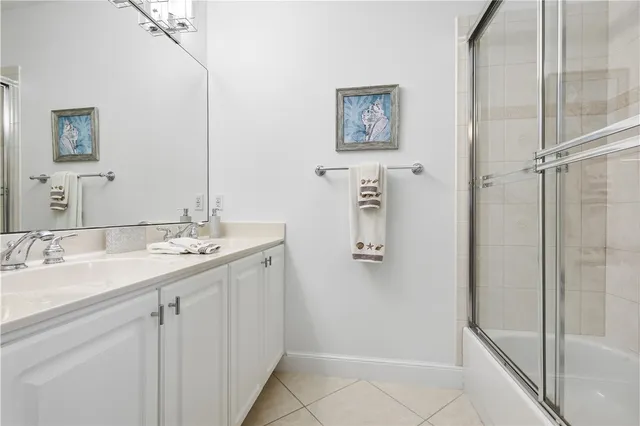 a bathroom with a double vanity sink a mirror and shower