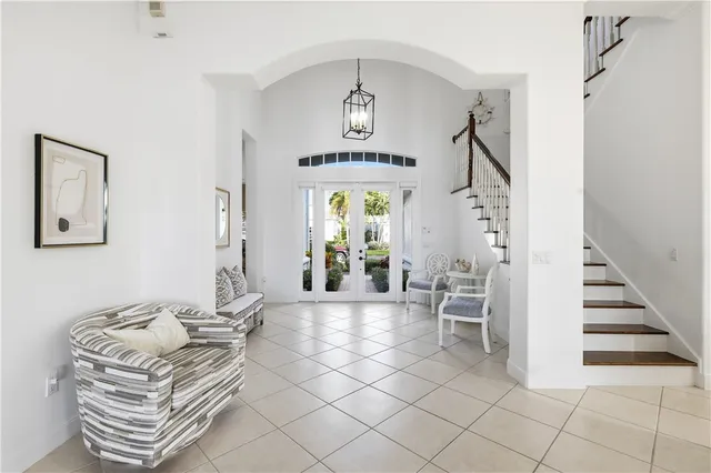a living room with furniture a chandelier and a window