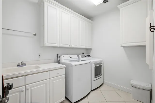a utility room with sink dryer and washer