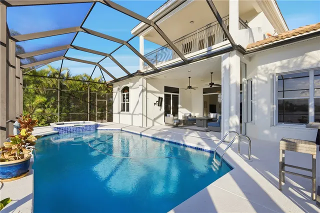 a view of a swimming pool with outdoor seating