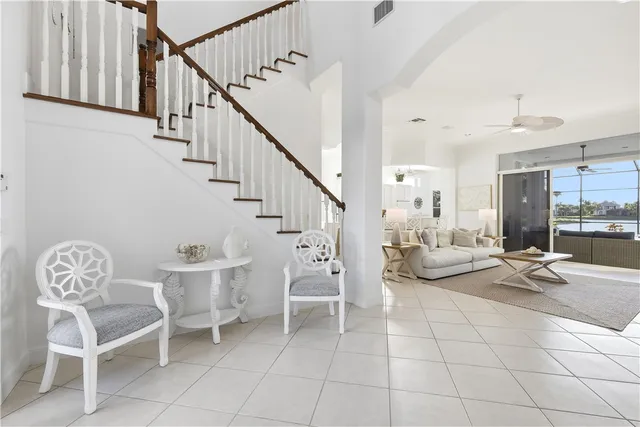 a living room with furniture a table and chairs