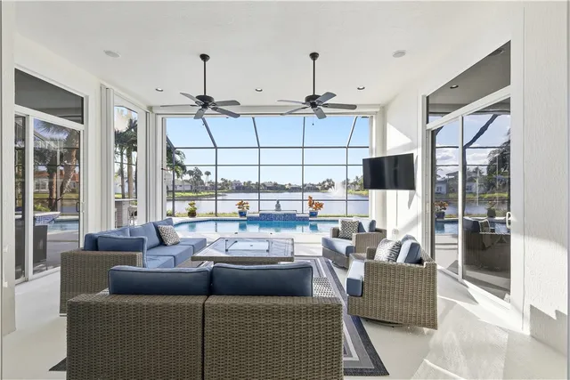a living room with furniture and a floor to ceiling window