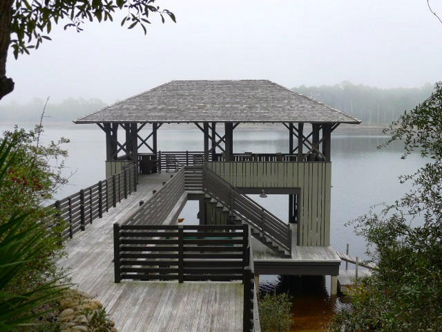 Lot 1-bk West Cedar Bend Road Santa Rosa Beach, FL 32459 - Photo 3 of 7 a view of a roof deck with table and chairs with wooden floor and fence