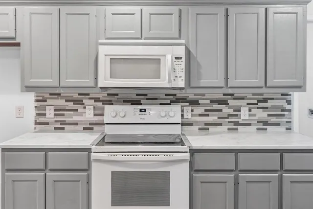 a kitchen with cabinets appliances and a sink