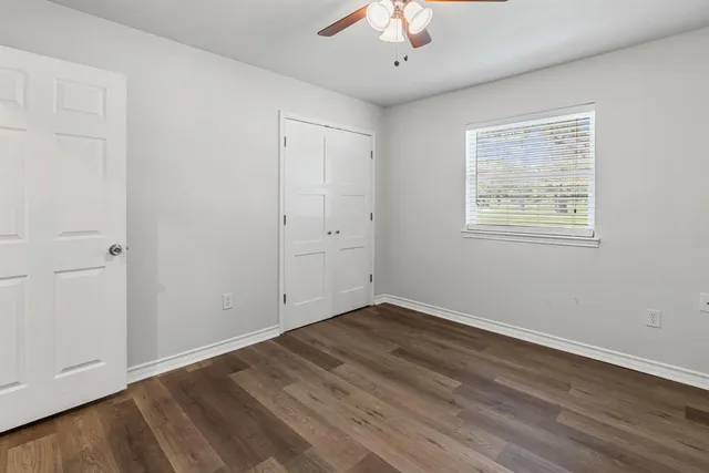 wooden floor in an empty room with a window