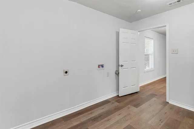 an empty room with wooden floor