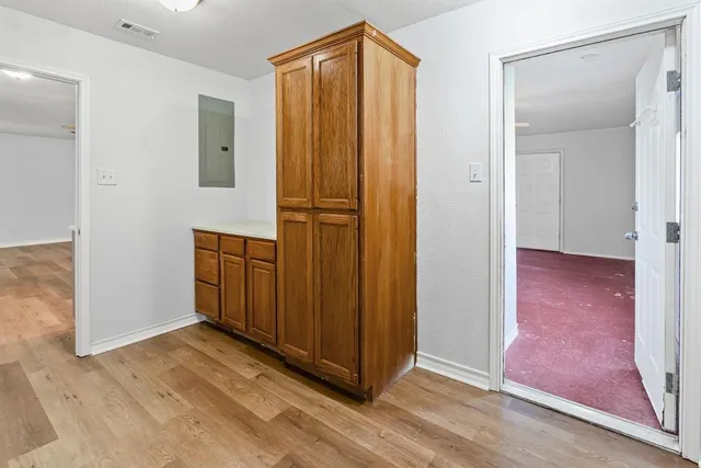 a view of a hallway with wooden floor