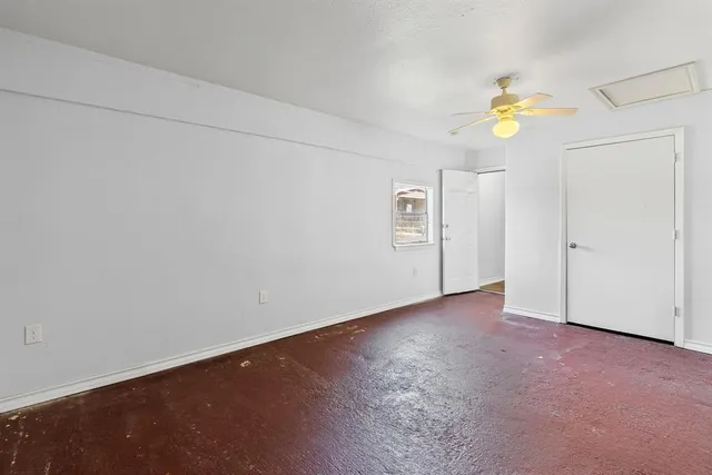 an empty room with a window and flowerpot