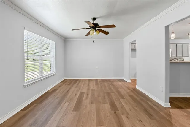 a view of a room with wooden floor closet and windows