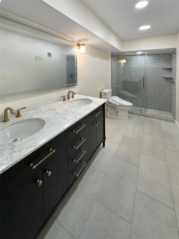 2301 Ridgmar Plaza, Unit 5 Fort Worth, TX 76116 - Photo 11 of 20 Full bathroom featuring double vanity and a shower stall