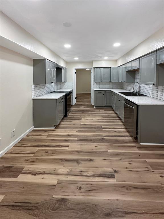 2301 Ridgmar Plaza, Unit 5 Fort Worth, TX 76116 - Photo 16 of 20 Kitchen featuring gray cabinets, tasteful backsplash, and dishwasher