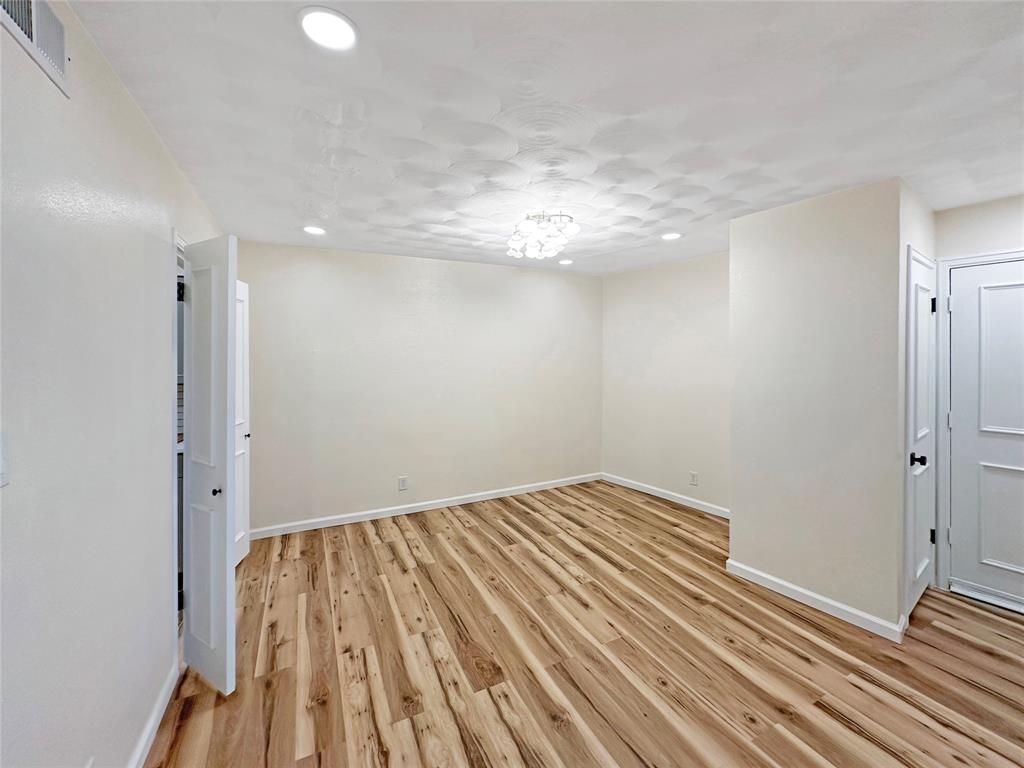 2301 Ridgmar Plaza, Unit 5 Fort Worth, TX 76116 - Photo 4 of 20 Dining room featuring light wood-type flooring and modern light fixture