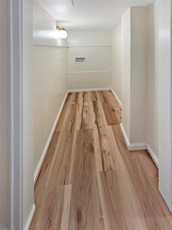 2301 Ridgmar Plaza, Unit 5 Fort Worth, TX 76116 - Photo 5 of 20 Hall with baseboards and light wood finished floors