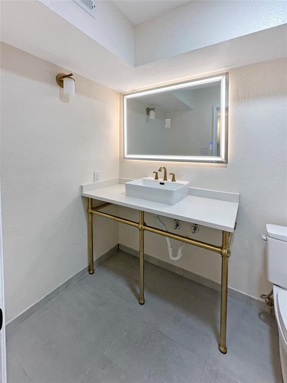 2301 Ridgmar Plaza, Unit 5 Fort Worth, TX 76116 - Photo 6 of 20 Hall bathroom featuring a textured wall and vanity