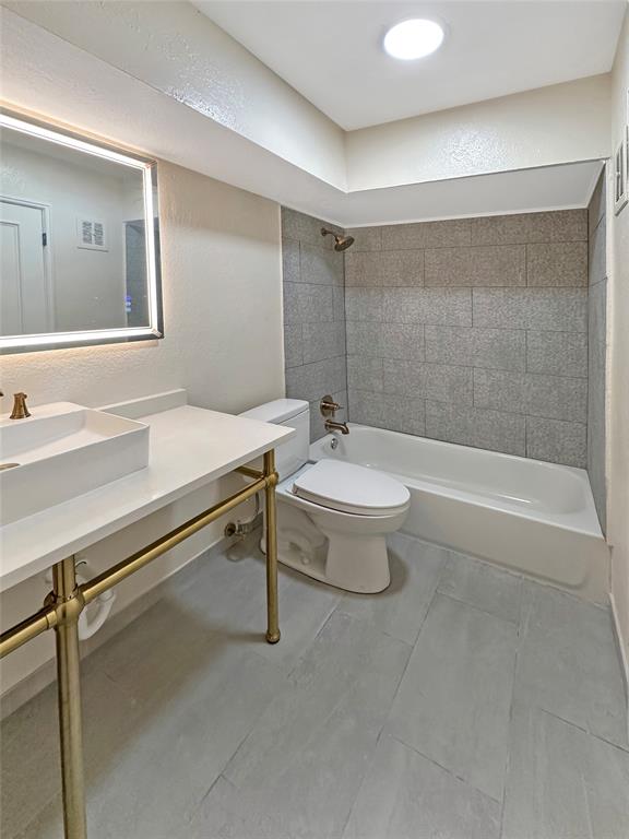 2301 Ridgmar Plaza, Unit 5 Fort Worth, TX 76116 - Photo 7 of 20 Full bath featuring shower combination, a textured wall, and vanity