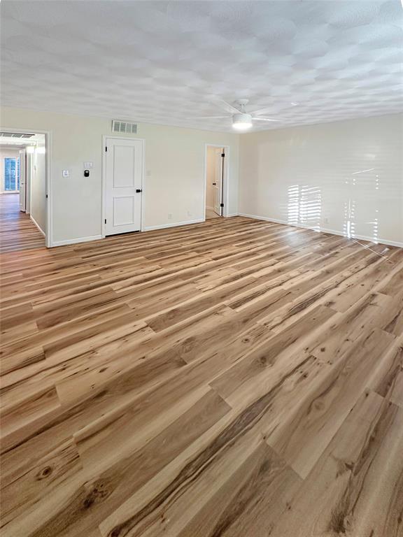 2301 Ridgmar Plaza, Unit 5 Fort Worth, TX 76116 - Photo 10 of 20 Primary bedroom featuring light wood-type flooring and baseboards