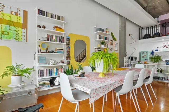 a view of a dining room with furniture and a floor to ceiling window