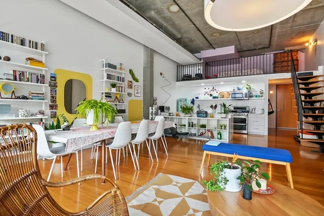 a dining room with furniture and wooden floor