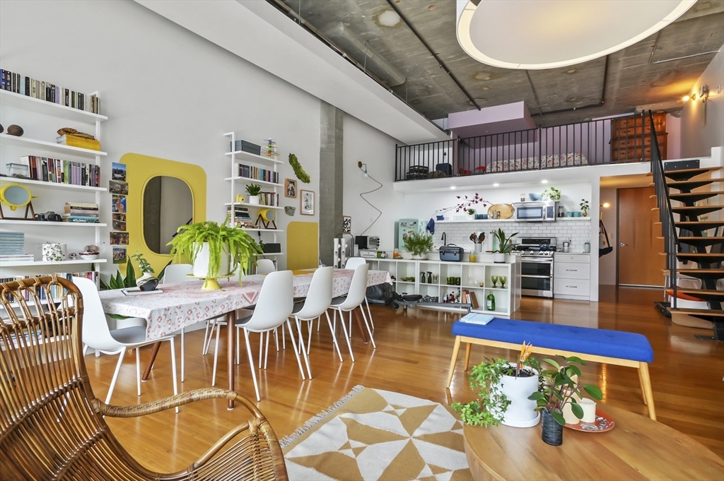 156 Porter Street, Unit 246 Boston, MA 02128 - Photo 12 of 25 a dining room with furniture and wooden floor