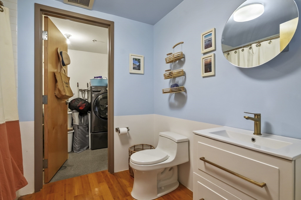 156 Porter Street, Unit 246 Boston, MA 02128 - Photo 17 of 25 a bathroom with a toilet a sink and mirror