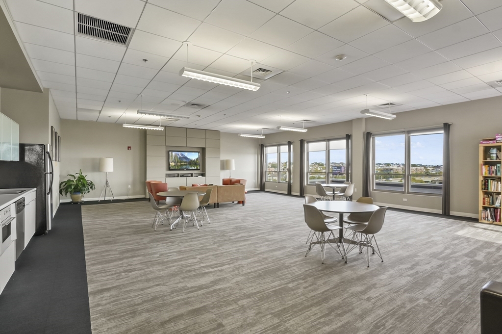 156 Porter Street, Unit 246 Boston, MA 02128 - Photo 20 of 25 a living room with furniture and a table