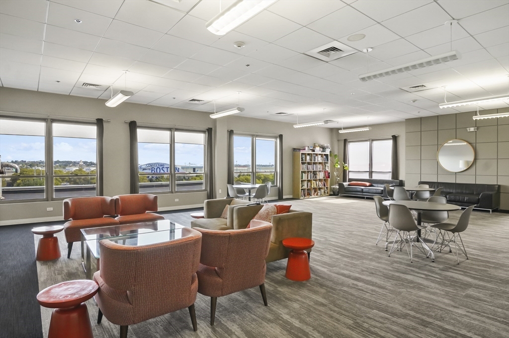 156 Porter Street, Unit 246 Boston, MA 02128 - Photo 22 of 25 a dining room with furniture large window and wooden floor