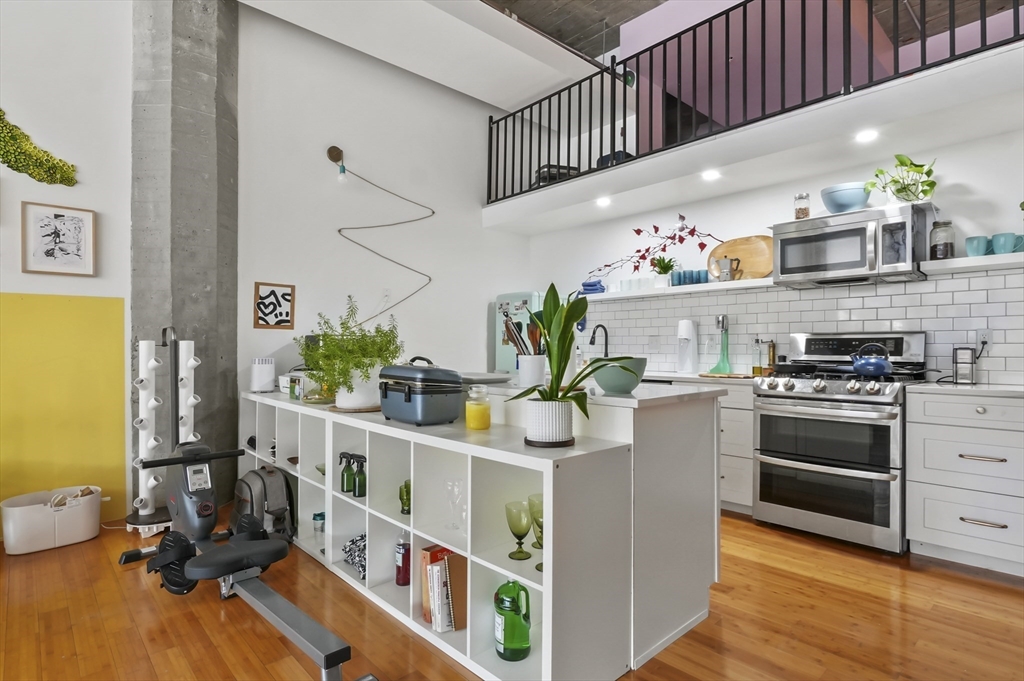 156 Porter Street, Unit 246 Boston, MA 02128 - Photo 3 of 25 a kitchen with stainless steel appliances a stove a chimney a sink and cabinets