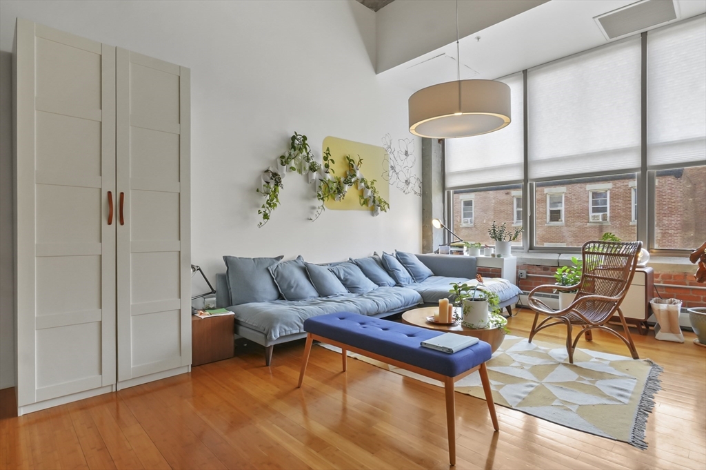 156 Porter Street, Unit 246 Boston, MA 02128 - Photo 7 of 25 a living room with furniture a window and a table