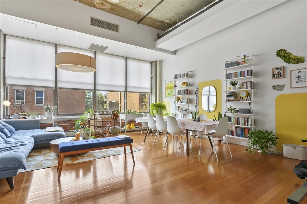 156 Porter Street, Unit 246 Boston, MA 02128 - Photo 9 of 25 a living room with fireplace furniture and a large window