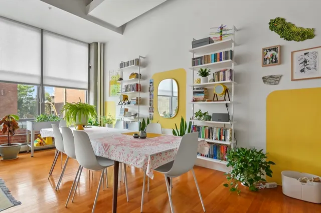 a view of a dining room with furniture and a potted plant