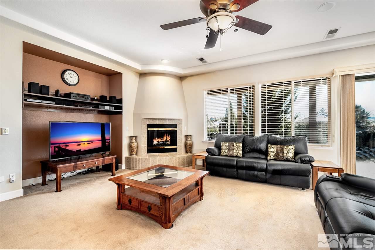 2630 Fury Court Reno, NV 89521 - Photo 12 of 25 a living room with furniture a flat screen tv and a fireplace
