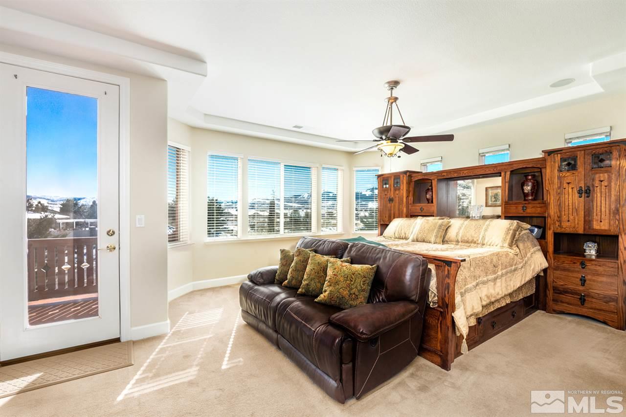 2630 Fury Court Reno, NV 89521 - Photo 13 of 25 a spacious bedroom with a bed couch and window