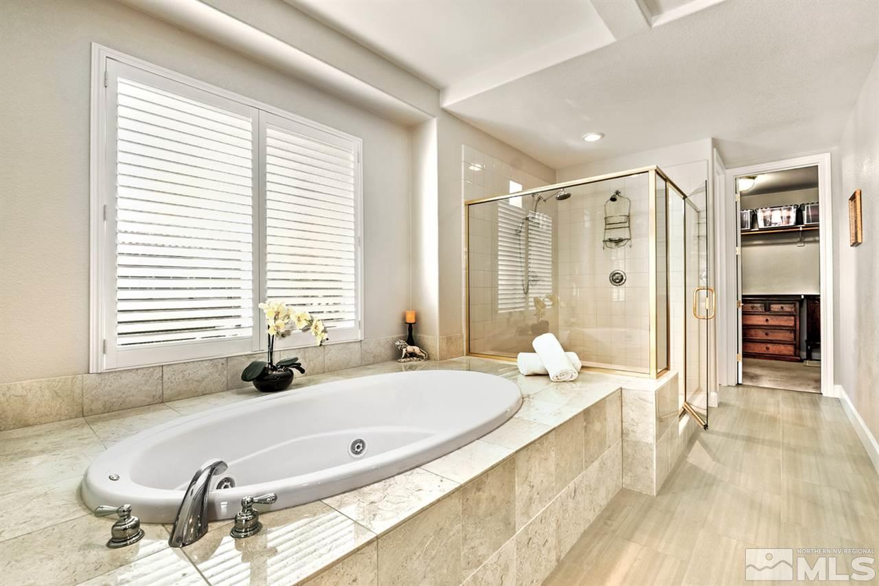 2630 Fury Court Reno, NV 89521 - Photo 14 of 25 a bathroom with a tub a double vanity sink and mirror