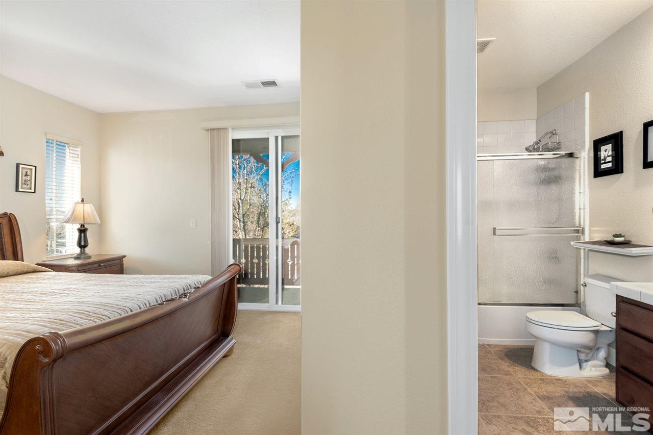 2630 Fury Court Reno, NV 89521 - Photo 18 of 25 a spacious bedroom with a bed and a view of bathroom