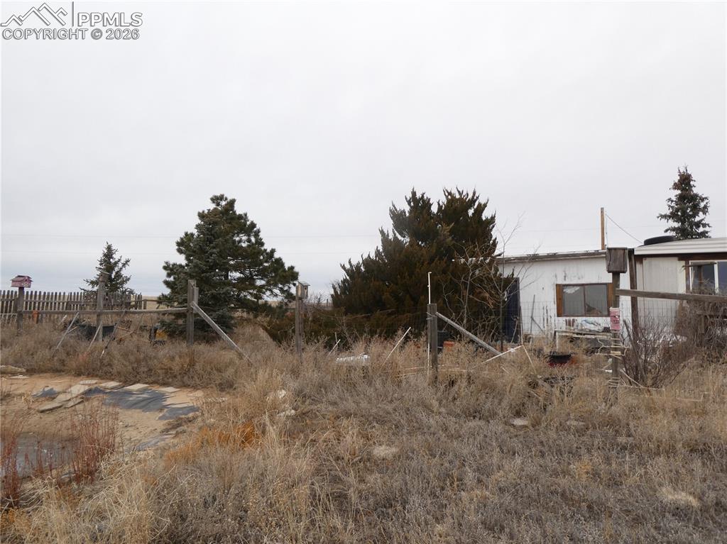 32775 Truckton Road Yoder, CO 80864 - Photo 5 of 15 a view of a dry yard with wooden fence
