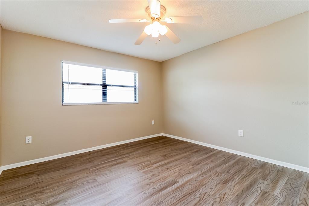 Undisclosed Address Spring Hill, FL 34609 - Photo 11 of 15 wooden floor in an empty room with a window