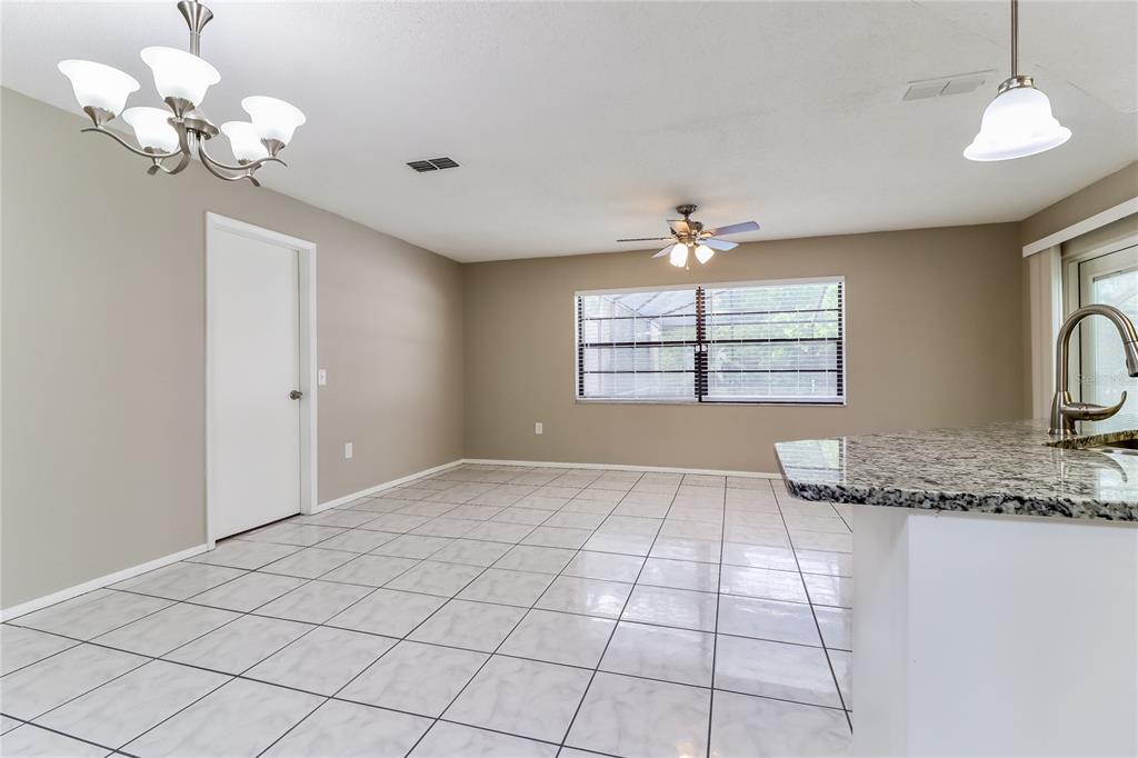 Undisclosed Address Spring Hill, FL 34609 - Photo 2 of 15 a view of a livingroom with a chandelier furniture and windows