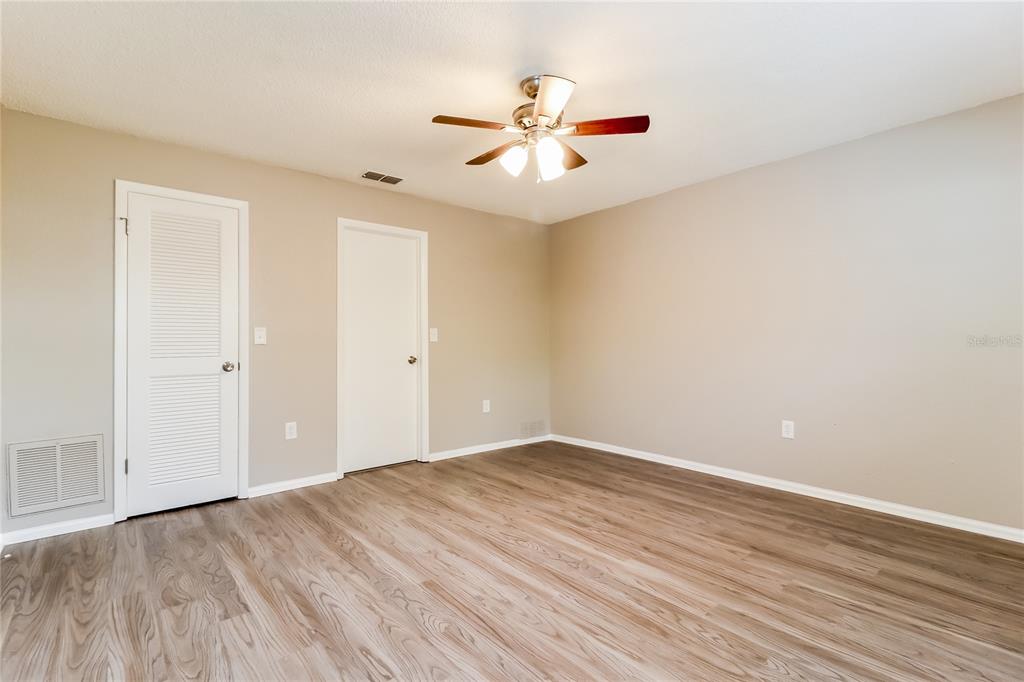 Undisclosed Address Spring Hill, FL 34609 - Photo 8 of 15 a view of an empty room with wooden floor