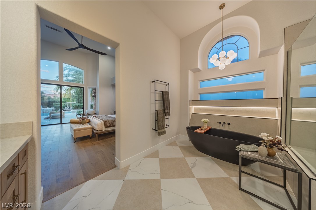 8800 Lusso Las Vegas, NV 89134 - Photo 54 of 85 Bathroom with ensuite bath, a soaking tub, a high ceiling, and vanity