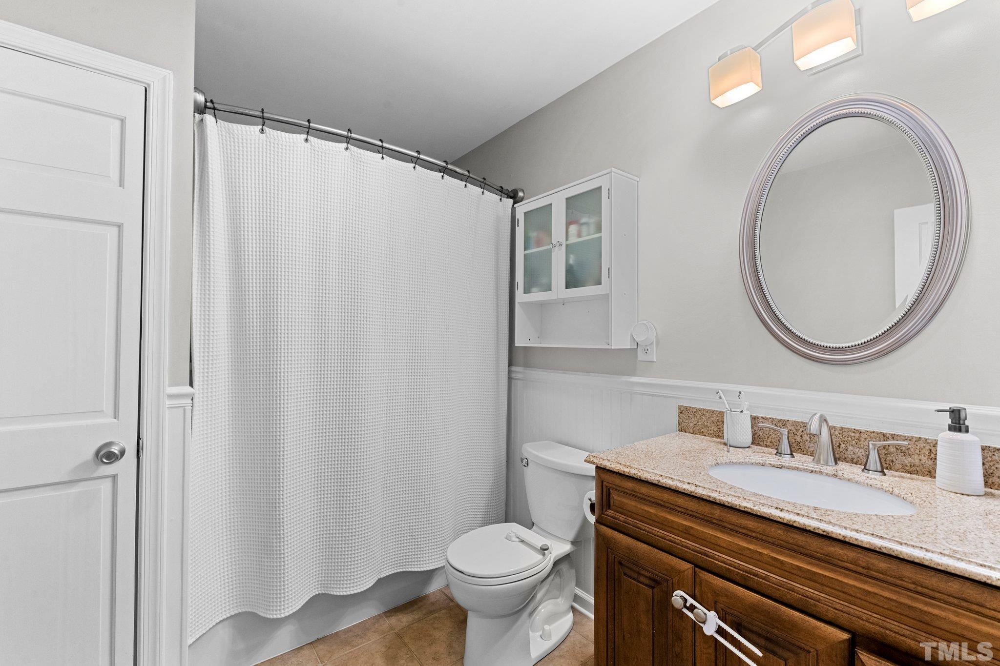 1212 Gatling Street Raleigh, NC 27610 - Photo 11 of 15 a bathroom with a granite countertop sink toilet and a mirror