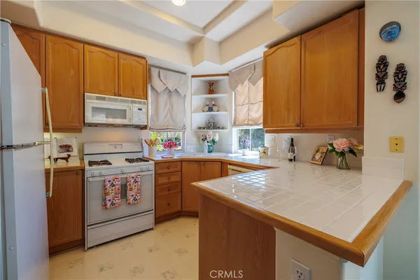 a kitchen with stainless steel appliances a stove a sink and a microwave