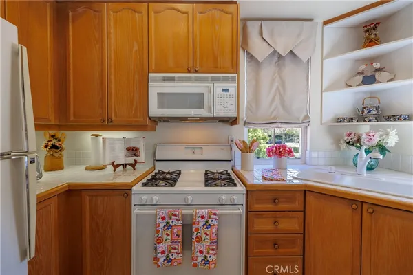 a kitchen with a sink window and cabinets