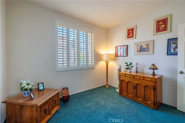 a bedroom with a bed and a lamp
